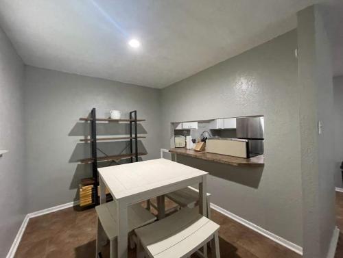 a room with a table and a counter with a kitchen at Charming 2-Bedroom 1-Bath Home Close to Downtown in Lawton