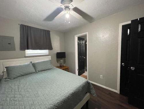 a bedroom with a bed and a ceiling fan at Charming 2-Bedroom 1-Bath Home Close to Downtown in Lawton