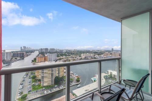 a balcony with chairs and a view of a city at Modern New Studio Balcony & Pool in Hallandale Beach