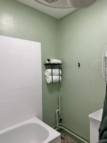 La salle de bains est pourvue d'une baignoire, de toilettes et de serviettes. dans l'établissement Le MONTLUSPOT, à Montluçon