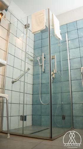 a bathroom with a shower with a glass door at Agathè Luxury Bed and Breakfast in Marina di Schiavonea