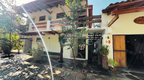 a house with a tree in front of it at Encino House Hotel Boutique in Valle de Bravo