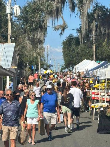 a large crowd of people walking down a street at Doras Dream, 4 Bedrooms, Sleeps 12, Downtown in Mount Dora