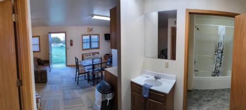 a bathroom with a sink and a mirror and a room at Cannon Dam Cabins in Shaver Ford