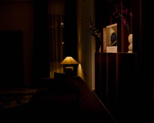 a lamp in the corner of a dark room at Nine A Apartment in Asaba