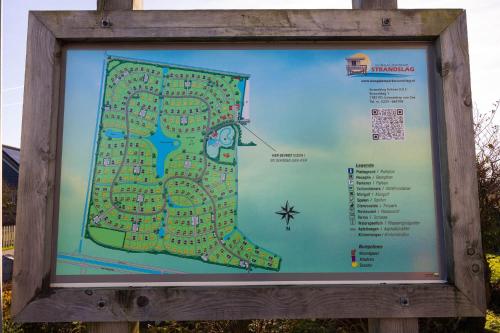 a sign with a map in a wooden frame at Tulip Beach in De Zandloper