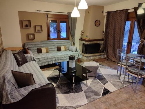 a living room with a couch and a table at Thodoris Apartment's in Eptalofos