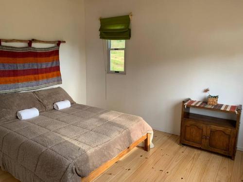 Postel nebo postele na pokoji v ubytování Cabaña de Campo, Chacra Gaia