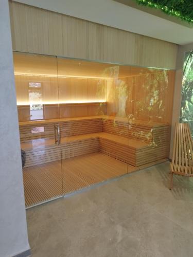 a room with a bench and a glass wall at Panorama Tornik S3 in Zlatibor