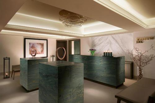 a lobby with a desk with a mirror on it at The St. Regis Astana in Astana