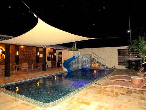 a swimming pool with a slide in a hotel at Mar e Lar in Maragogi