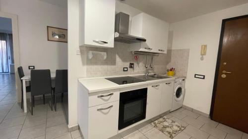 a white kitchen with a sink and a dishwasher at Sweet Home in Santa Marinella