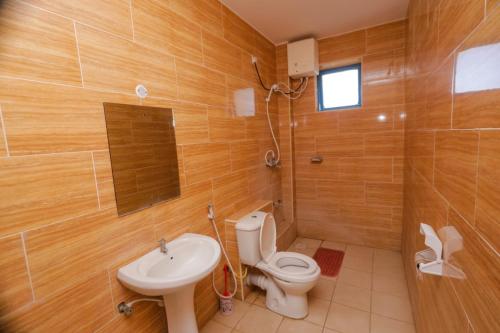 a bathroom with a toilet and a sink at 2 Bedroom Apartment in Links Road Nyali in Mombasa