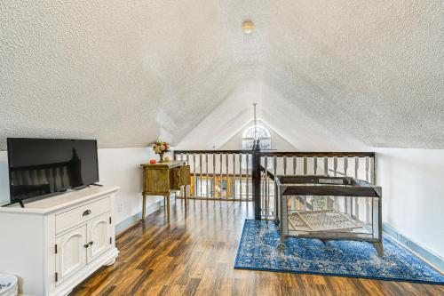 a living room with a tv and a table at 5 Mi to Blue Ridge Parkway Mountain Cabin in Cana in Fancy Gap