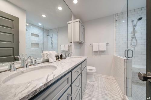 a white bathroom with a sink and a toilet at Luxury Family Beach Front Property! Family Oriented! Gulf Views! in Panama City Beach