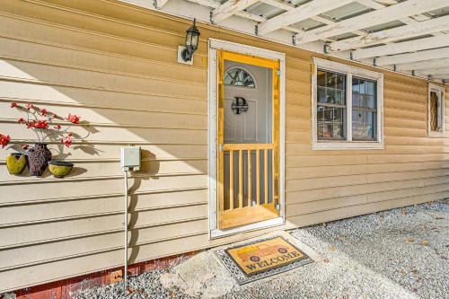 a house with a yellow door and a window at 5 Mi to Blue Ridge Parkway Mountain Cabin in Cana in Fancy Gap