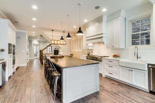 a kitchen with white cabinets and a black counter top at The Sono Chicago in Chicago