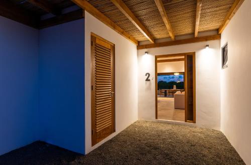 a room with a blue wall and a door at LXRY Villas in Jan Thiel