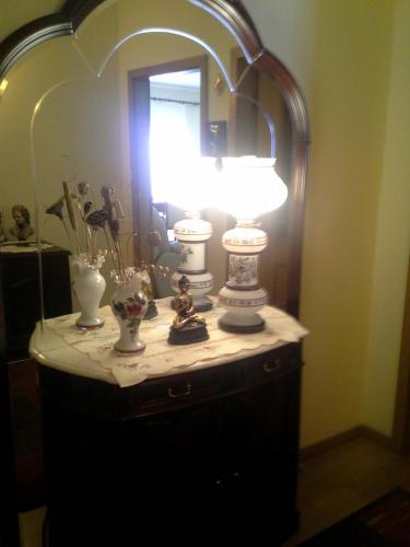 a lamp on a dresser in front of a mirror at Borges Pimentel Apartment in Ponta Delgada