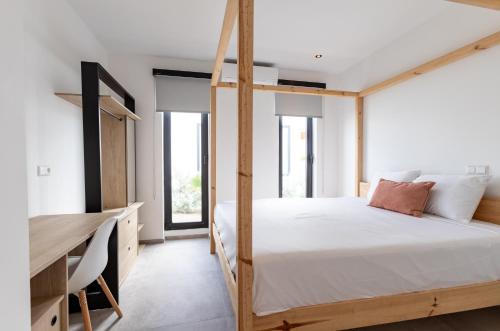 a bedroom with a wooden bunk bed and a desk at LXRY Villas in Jan Thiel