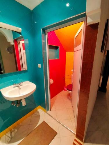 a bathroom with a sink and a mirror and a toilet at Appartement Imi-Ouaddar 2 in Imi Ouaddar