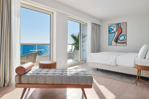 a bedroom with a bed and a large window at Le Meridien Lav Split in Podstrana