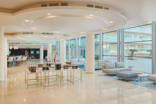 a lobby with couches and tables in a building at Le Meridien Lav Split in Podstrana
