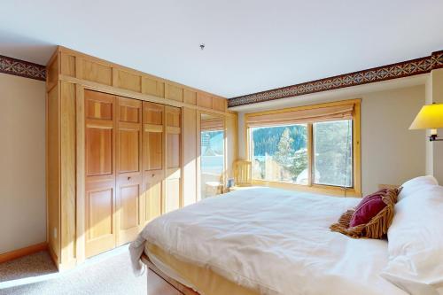 a bedroom with a large bed and a window at Shoshone 1922 in Big Sky