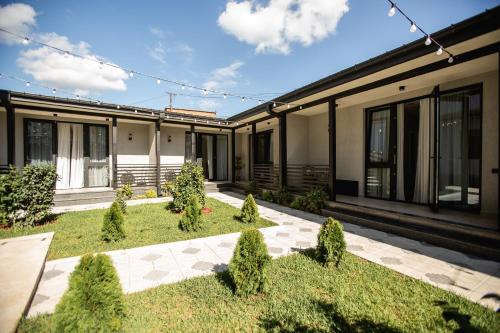an exterior view of a building with a garden at Central Inn in Kutaisi