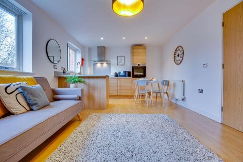 a living room with a couch and a kitchen at Stay Yorkshire 1st floor Hamilton Mews Apartment in Doncaster