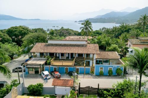 a house with a view of the water at VELINN Pousada Iguana Azul in Ilhabela