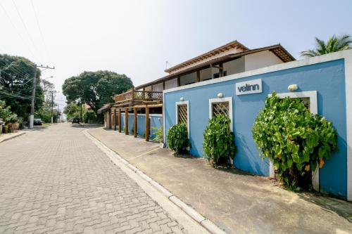 a blue building on the side of a street at VELINN Pousada Iguana Azul in Ilhabela