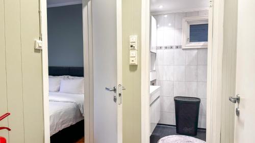 a door to a bedroom with a bed and a bathroom at Cozy apartment with free parking in Jar