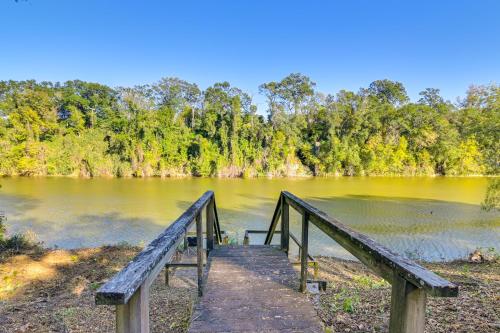 a wooden bridge over a body of water at Riverfront Fishing Home in Columbus with Grill in Columbus