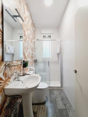 a bathroom with a sink and a toilet and a shower at Bilbao ROOMS & KITCHEN Irala in Bilbao