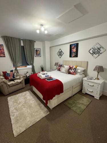 a bedroom with a large bed with a red blanket at LoughView BED & BREAKFAST in Belfast