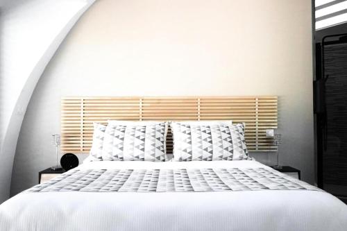 a white bed with white pillows in a bedroom at Gîte de France Game of dome - Gîte de France 4 personnes MAE-4601 in Chartrier-Ferrière