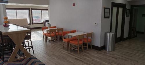 a restaurant with tables and chairs and a counter at Hampton Inn Birch Run in Birch Run