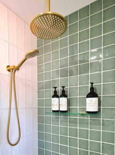 three bottles on a shelf in a bathroom at Bakery Cottage Moyhu in Moyhu