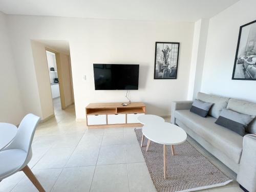 a living room with a couch and a table at Saavedra 118 6ºI by depptö in Bahía Blanca