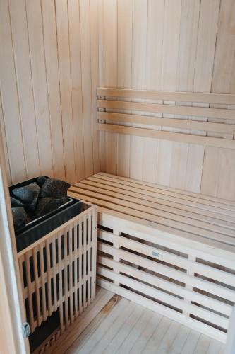 a sauna with two wooden shelves and a bed at Duplex Lomy vue sur le port avec Sauna-balneo-5mn plage in Pléneuf-Val-André