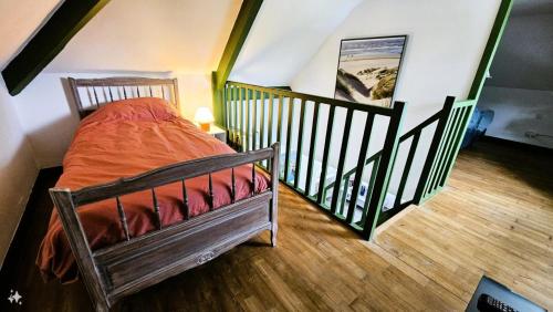 une chambre avec un lit dans une pièce avec un escalier dans l'établissement Gîte de France Pool house 3 épis - Gîte de France 3 personnes MAE-4641, à Brive-la-Gaillarde