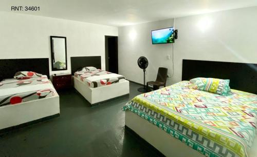 Una cama o camas en una habitación de Hospedaje DJ
