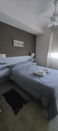 a bedroom with a large bed and a sink at Departamento Calchines con cochera in Santa Fe