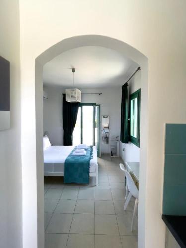 a bedroom with a bed and a room with a table at ANCIENT MEROPIA, Apollonia in Apollonia