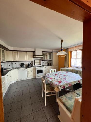 a kitchen with a table and a table and chairs at Apartment Elena in Gedersdorf