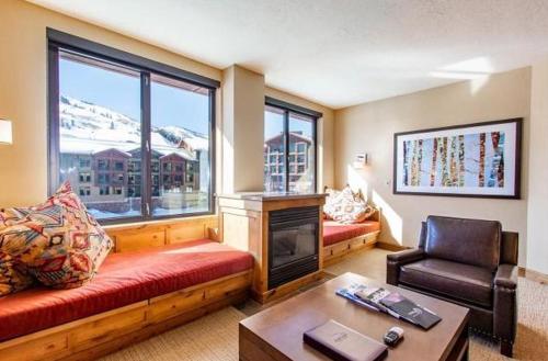 a living room with a couch and a fireplace at Grand Summit Hotel, Ski In Out, Pool, Hot Tub, Gym, Perfect Location! in Park City