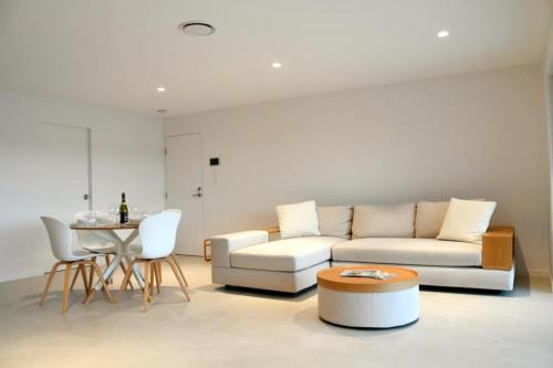 a living room with a couch and a table at RiverView GetAway in Maroochy River