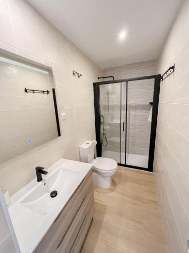 a bathroom with a white sink and a toilet at El rincón de María in Torremolinos