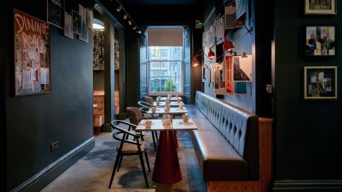 a row of tables in a room with a window at Hotel Indigo Edinburgh by IHG in Edinburgh